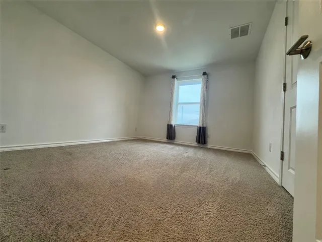 an empty room with windows and pillars in it