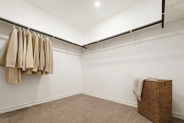 a view of walk in closet with clothes