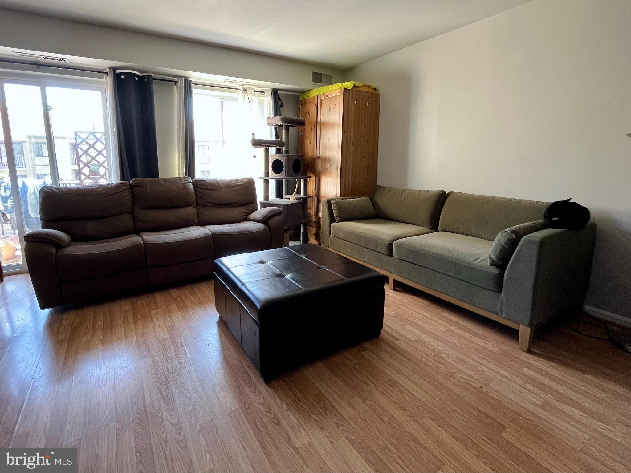 6153 Edsall Road, Unit E Alexandria, VA 22304 - Photo 3 of 12 a living room with furniture and a wooden floor