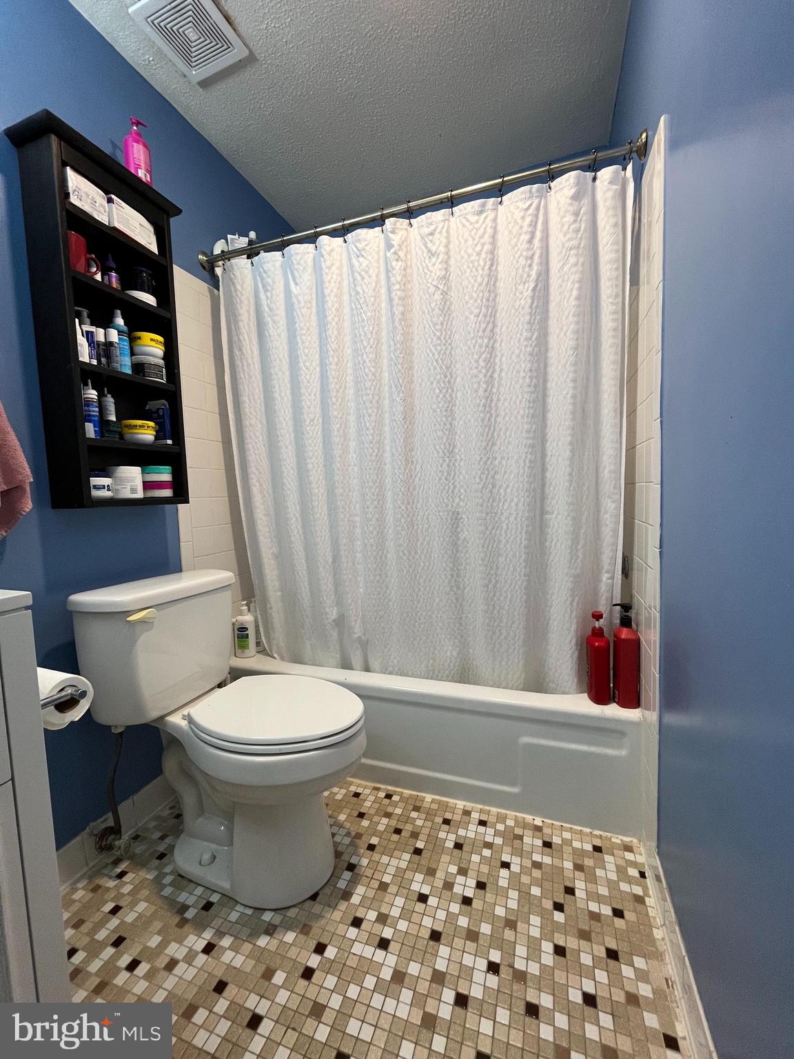 6153 Edsall Road, Unit E Alexandria, VA 22304 - Photo 5 of 12 a bathroom with a toilet and a shower curtain