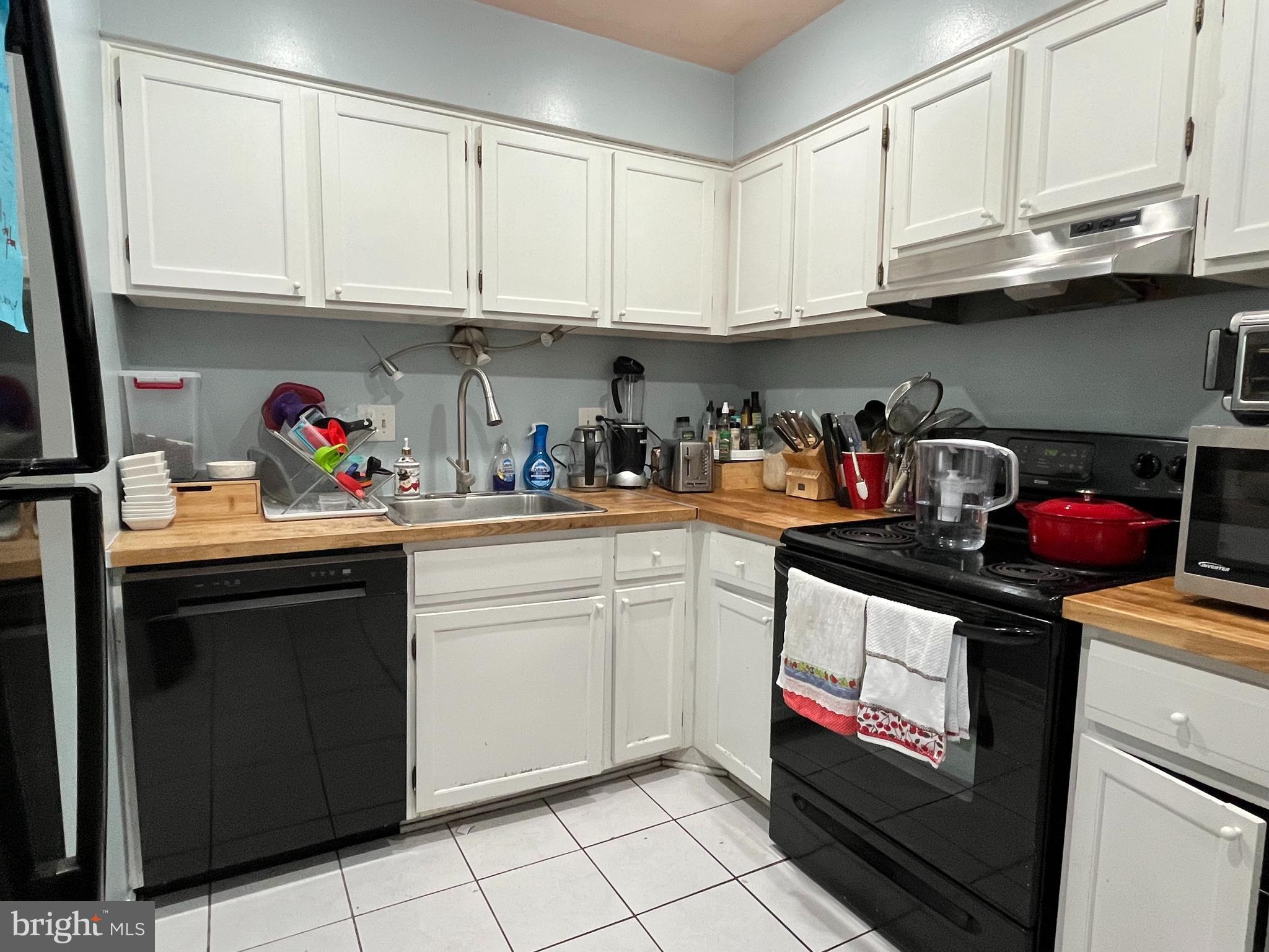 6153 Edsall Road, Unit E Alexandria, VA 22304 - Photo 8 of 12 a kitchen with stainless steel appliances granite countertop a sink dishwasher stove and cabinets