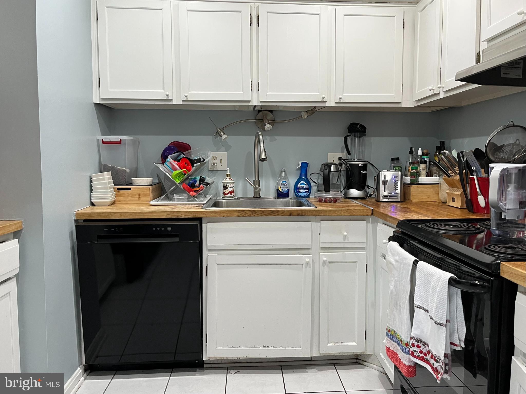 6153 Edsall Road, Unit E Alexandria, VA 22304 - Photo 9 of 12 a kitchen with stainless steel appliances granite countertop a sink and cabinets