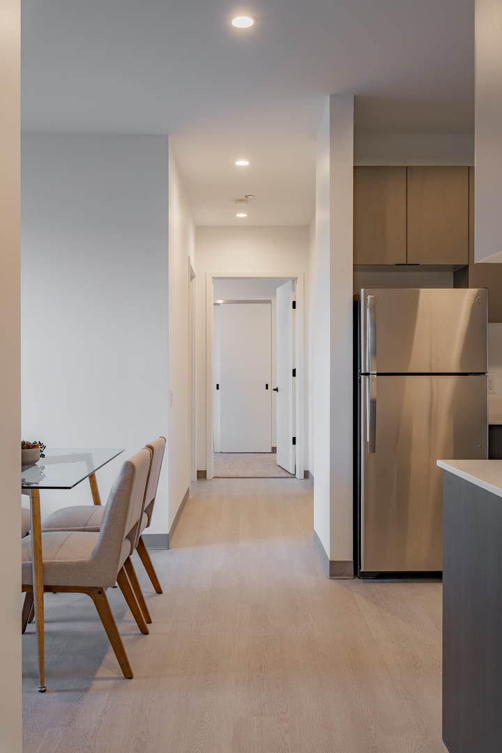 Undisclosed Address Chicago, IL 60642 - Photo 3 of 15 a view of a kitchen with refrigerator and furniture
