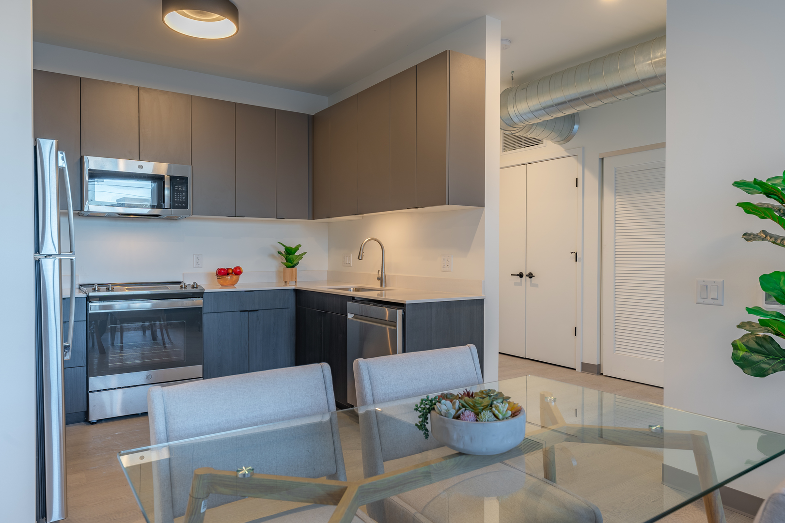 Undisclosed Address Chicago, IL 60642 - Photo 4 of 15 a kitchen with stainless steel appliances a white refrigerator a stove a sink and dishwasher