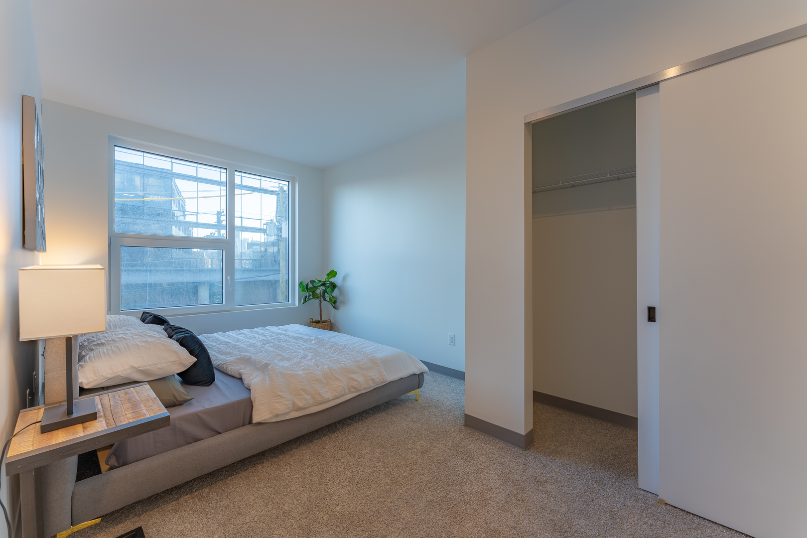 Undisclosed Address Chicago, IL 60642 - Photo 8 of 15 a bedroom with a bed and windows