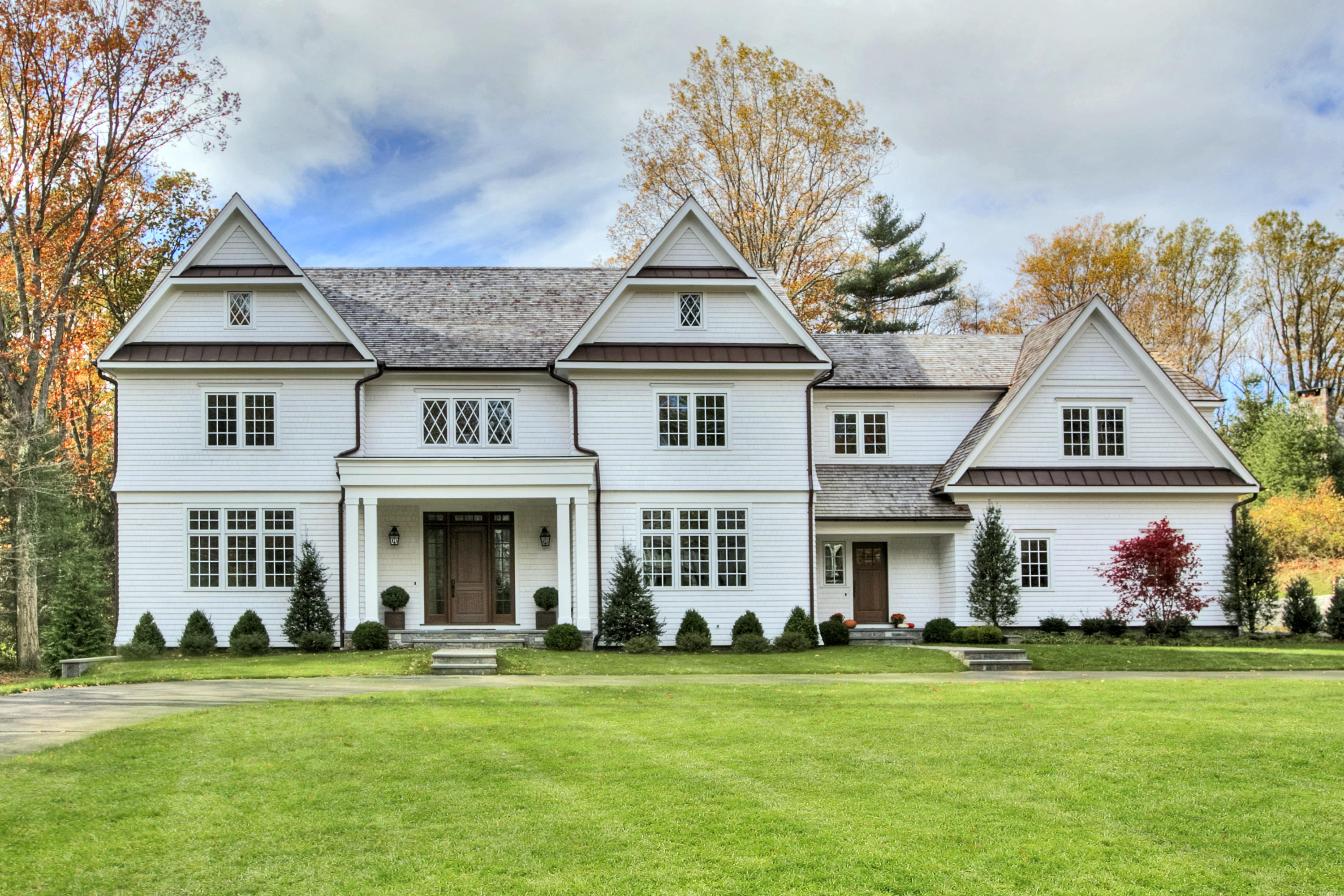 a front view of a house with a garden
