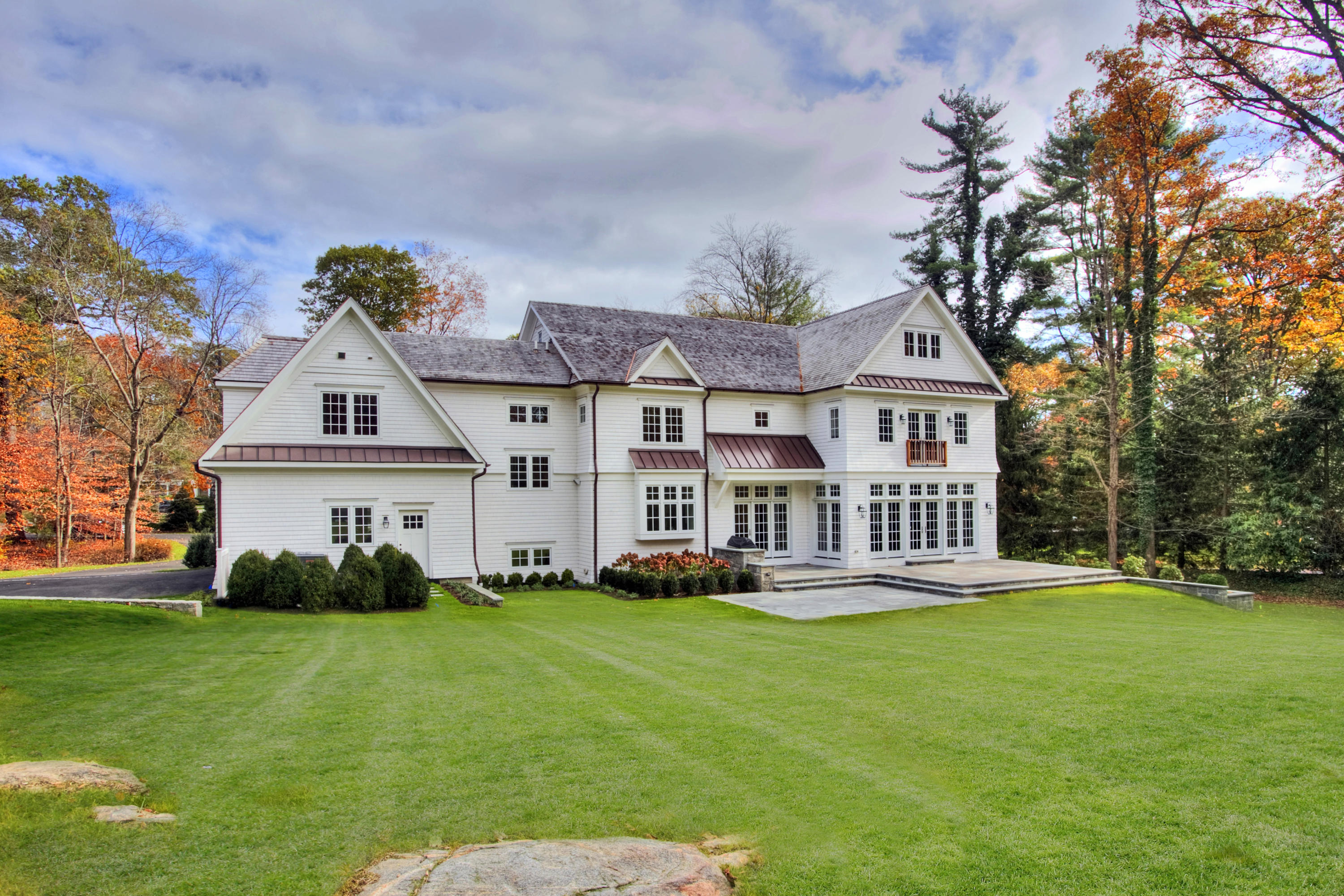 61 Stony Brook Road Darien, CT 06820 - Photo 2 of 43 a front view of a house with a yard table and chairs