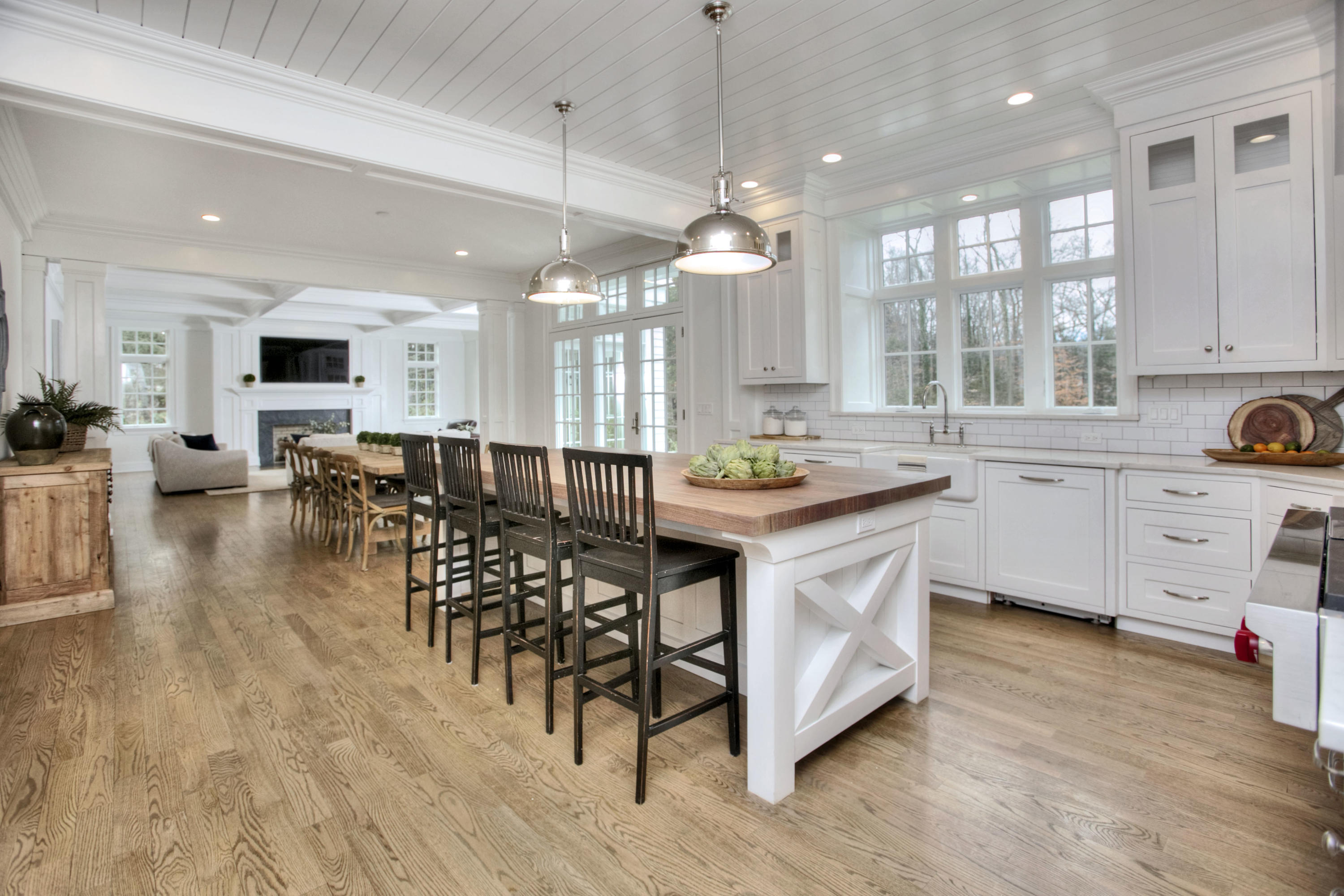 61 Stony Brook Road Darien, CT 06820 - Photo 20 of 43 a open kitchen with stainless steel appliances granite countertop a stove top oven a sink dishwasher and white cabinets with wooden floor