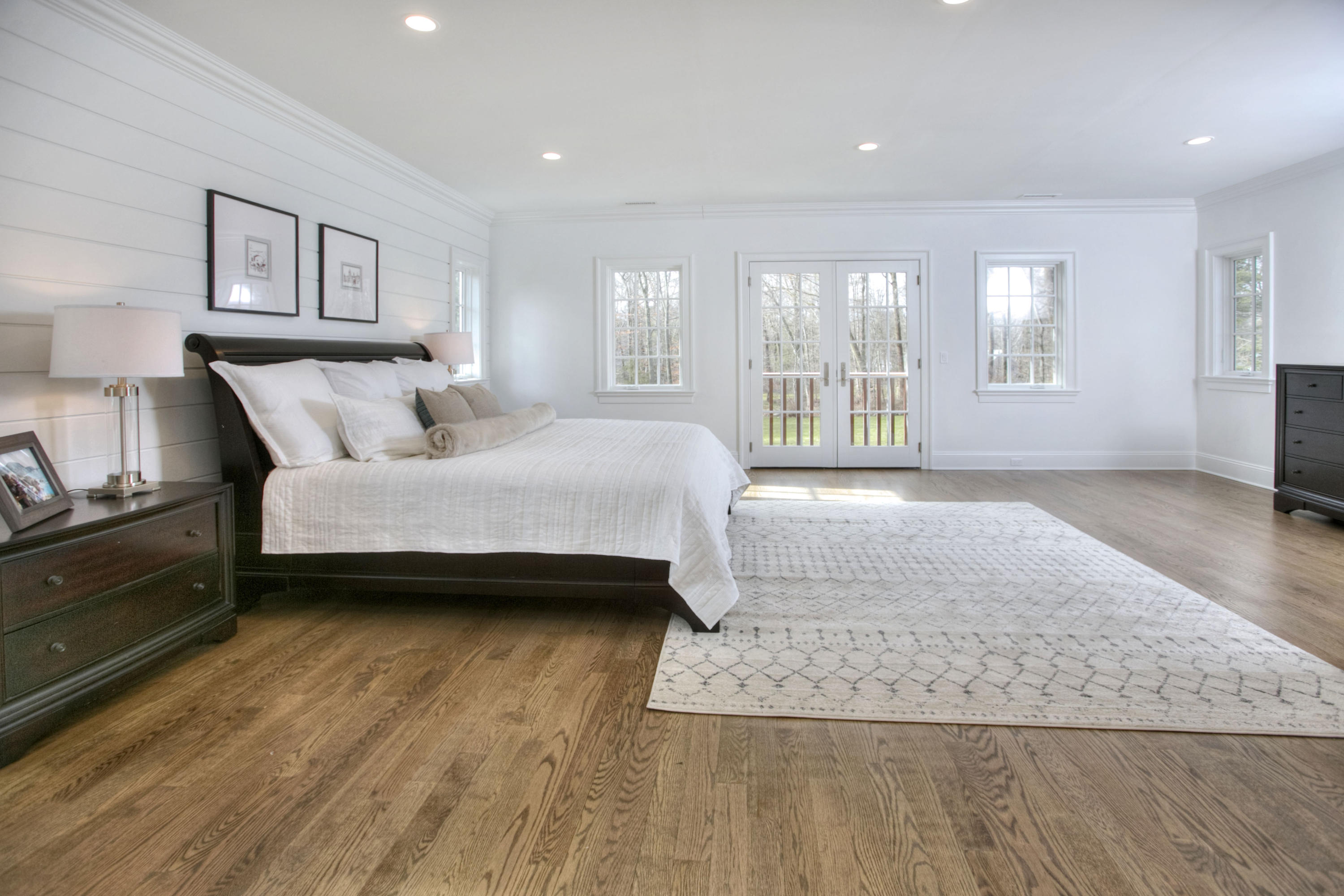 61 Stony Brook Road Darien, CT 06820 - Photo 29 of 43 a spacious bedroom with a bed a couch and large window