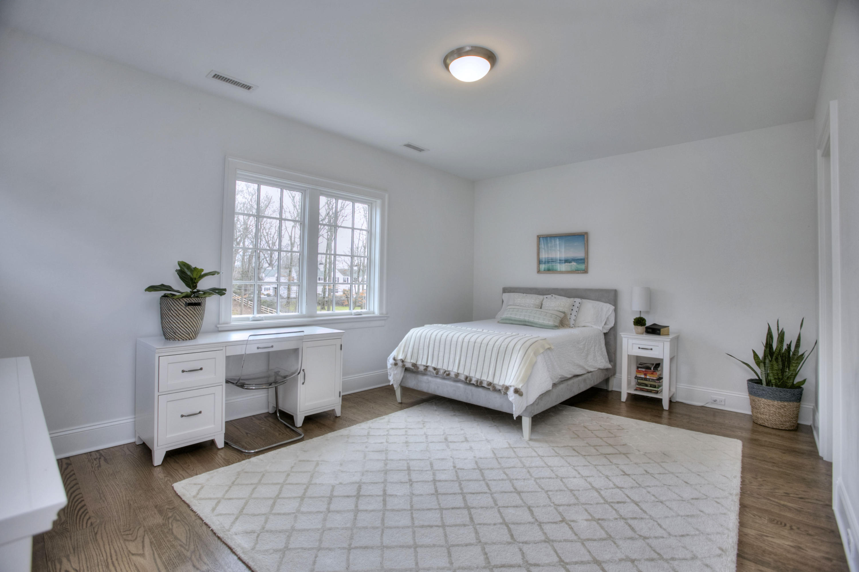 61 Stony Brook Road Darien, CT 06820 - Photo 33 of 43 a spacious bedroom that has a bed and a table chair in it