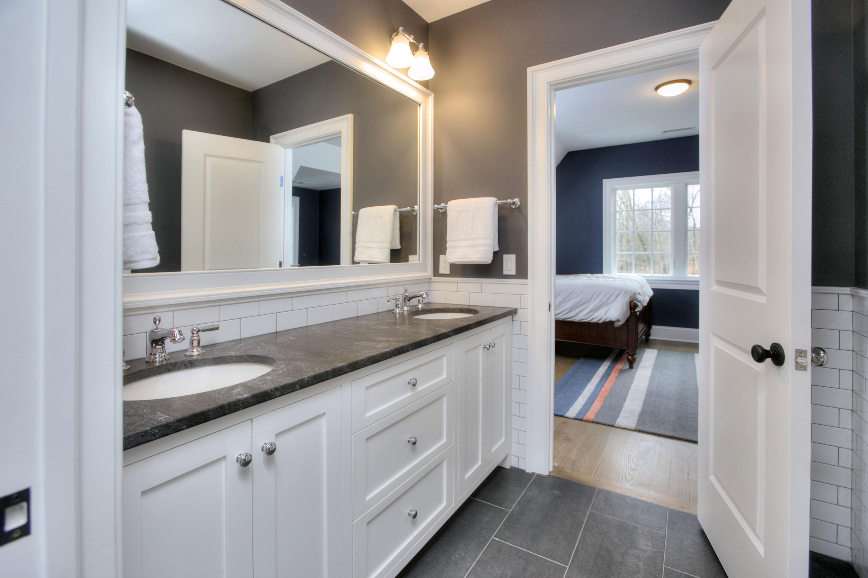 61 Stony Brook Road Darien, CT 06820 - Photo 35 of 43 a en suite bathroom with a granite countertop sink and a mirror