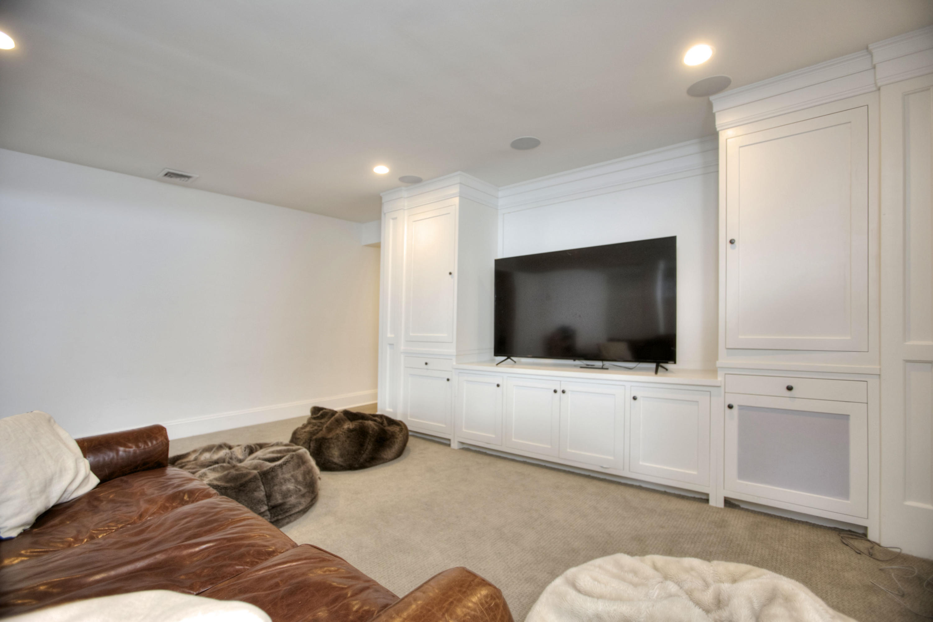 61 Stony Brook Road Darien, CT 06820 - Photo 39 of 43 a living room with furniture and a flat screen tv