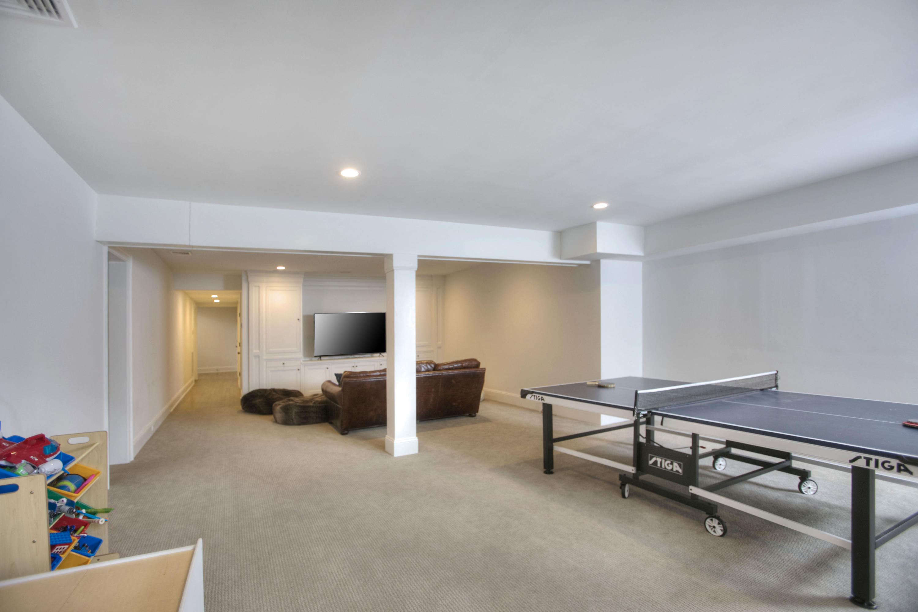 61 Stony Brook Road Darien, CT 06820 - Photo 41 of 43 a living room with furniture gym equipment and a flat screen tv