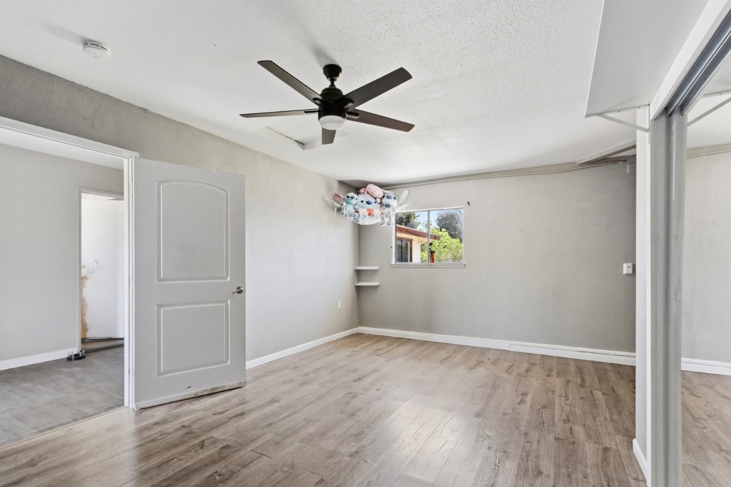 7208 7th Street Rio Linda, CA 95673 - Photo 15 of 41 a view of a livingroom with wooden floor and a ceiling fan