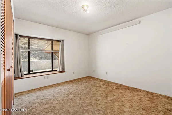 a view of a big room with closet and wooden floor