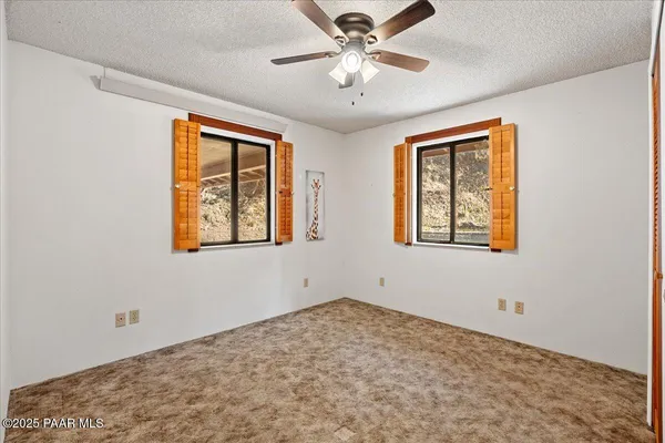a view of a kitchen with fridge and front door