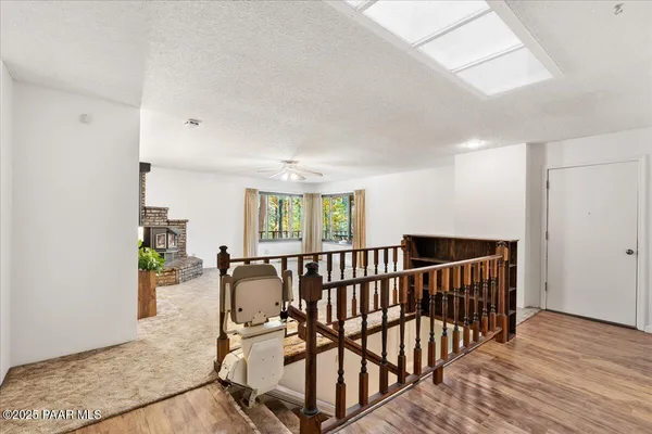 an empty room with fireplace and windows
