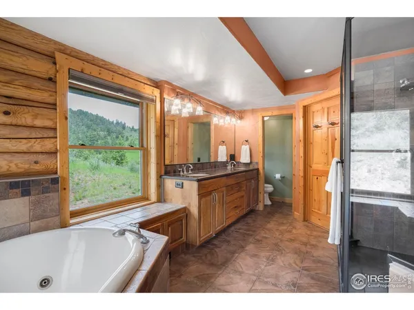 a bathroom with a tub sink and mirror