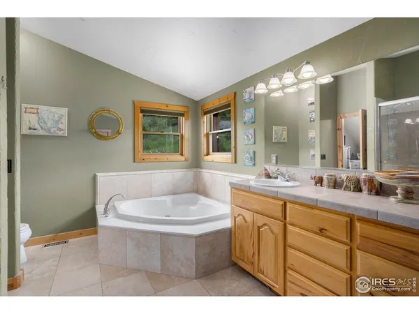 a bathroom with a sink mirror and a bathtub