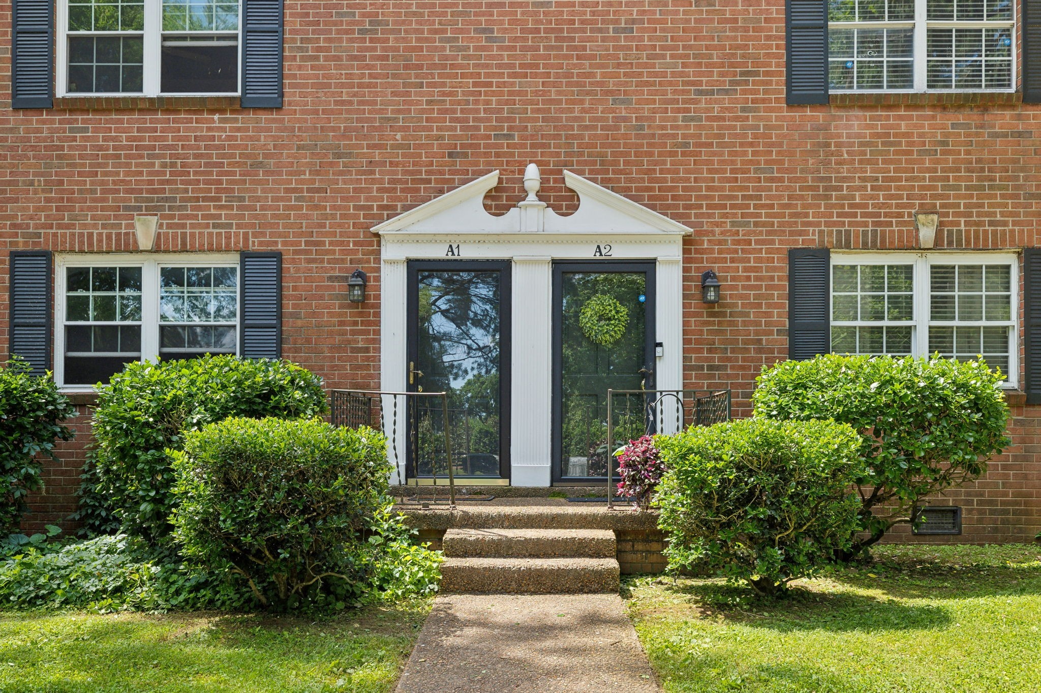 a front view of a house with garden