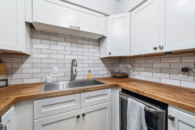 a kitchen with a sink and cabinets
