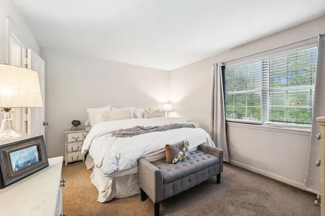 a bedroom with a bed and flat screen tv