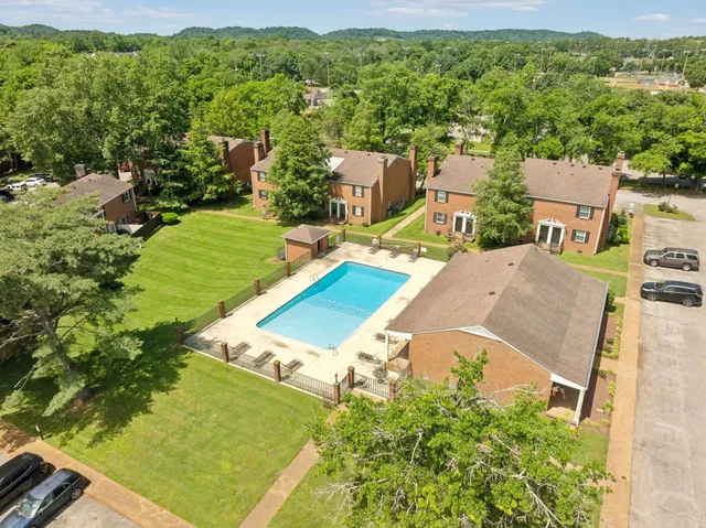 an aerial view of a house with a yard and lake view
