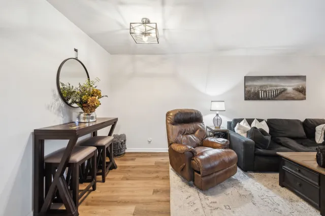 a living room with furniture and a chandelier