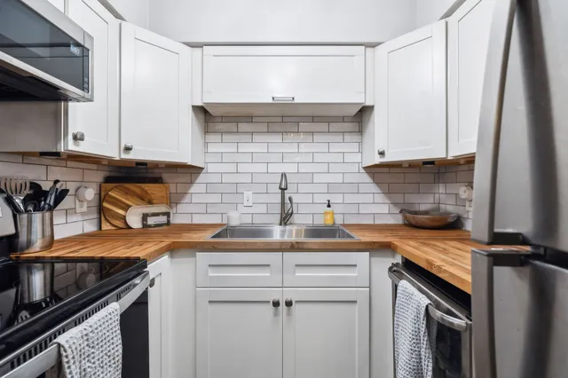 a kitchen with a sink and cabinets