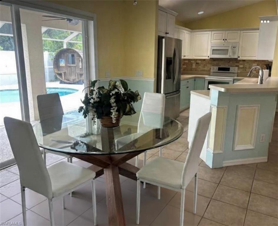 121 Ginger Road Venice, FL 34293 - Photo 11 of 34 a dining room with furniture a window and stainless steel appliances