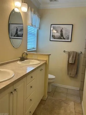 a bathroom with a toilet a sink and a mirror