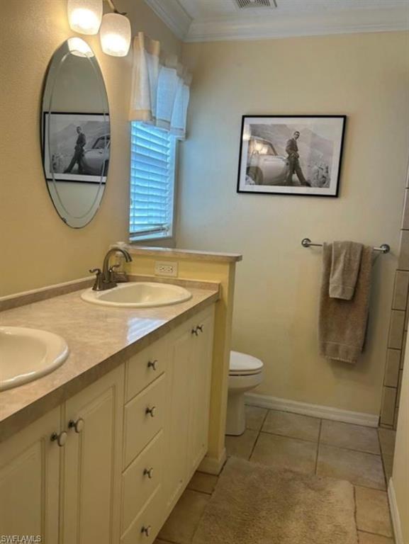 121 Ginger Road Venice, FL 34293 - Photo 21 of 34 a bathroom with a toilet a sink and a mirror