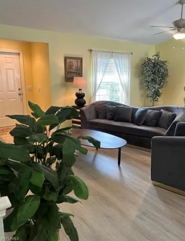 a living room with furniture rug and window