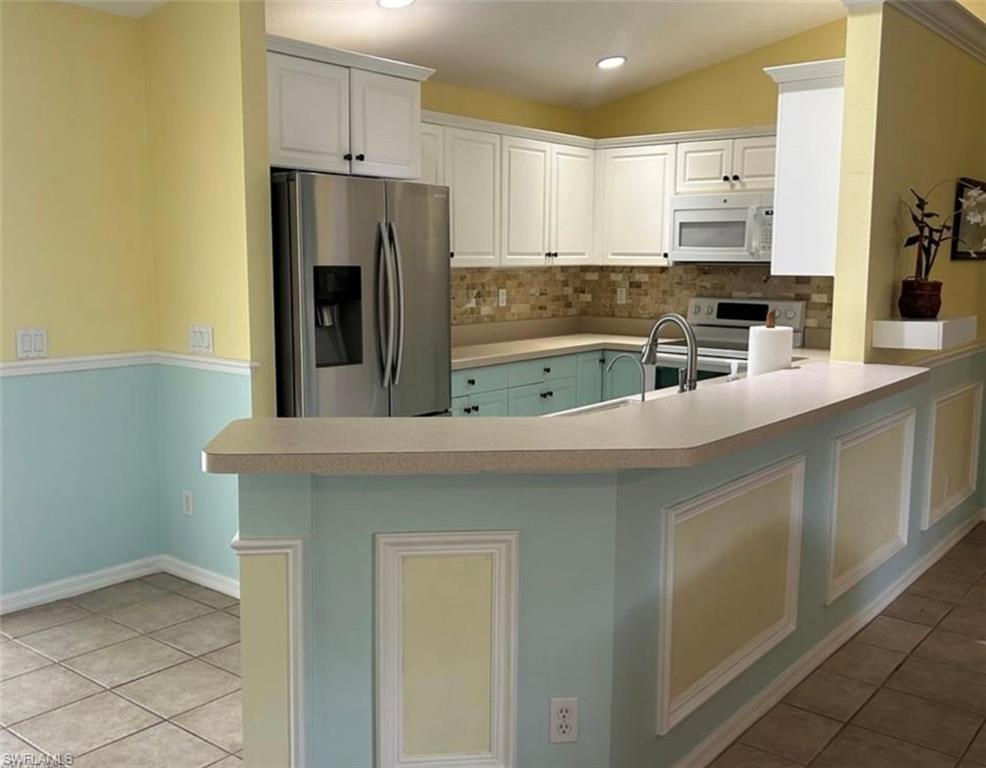 121 Ginger Road Venice, FL 34293 - Photo 7 of 34 a kitchen with stainless steel appliances a refrigerator and a stove top oven