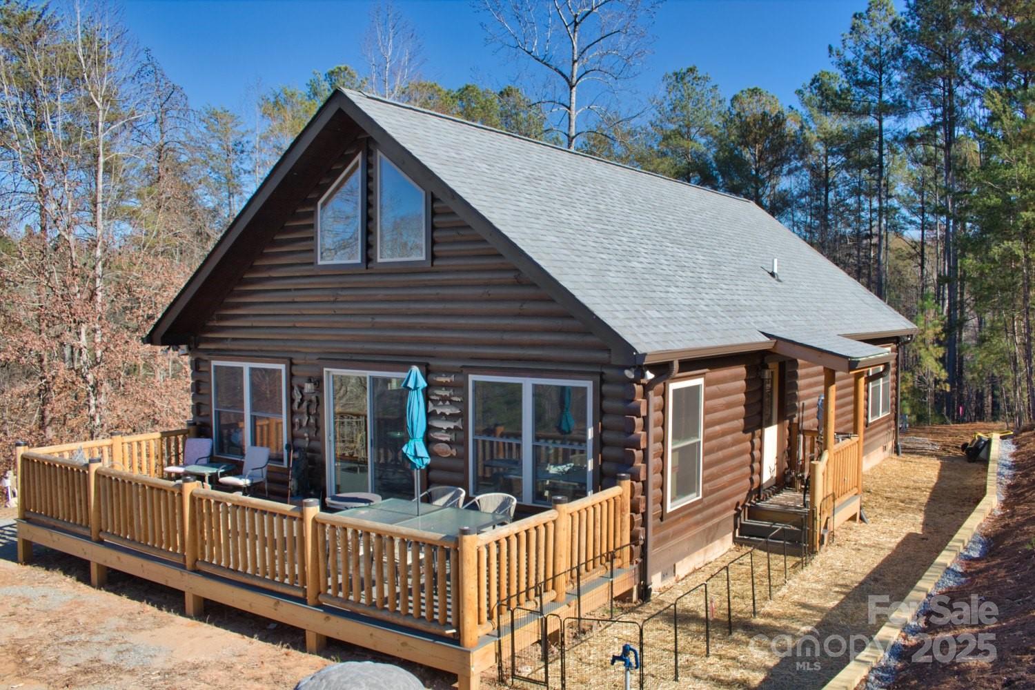 a view of a house with wooden deck and furniture