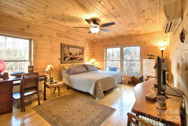 a spacious bedroom with a bed and a table in it