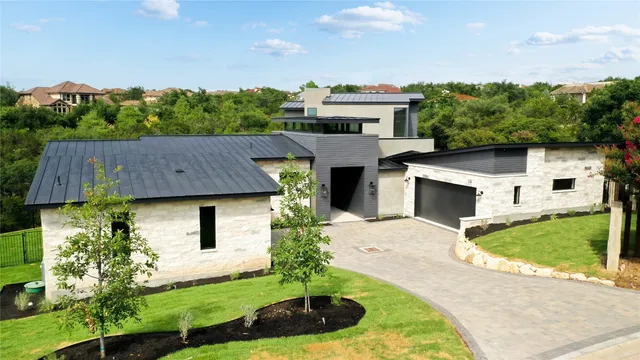 aerial view of a house with a yard and potted plants