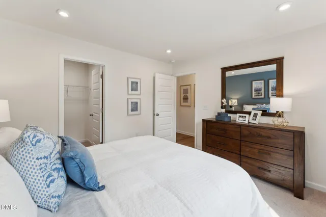 a bedroom with a large bed and a dresser