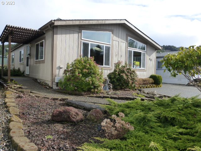 100 River Bend Road, Unit 80 Reedsport, OR 97467 - Photo 1 of 22 a front view of house with yard and green space