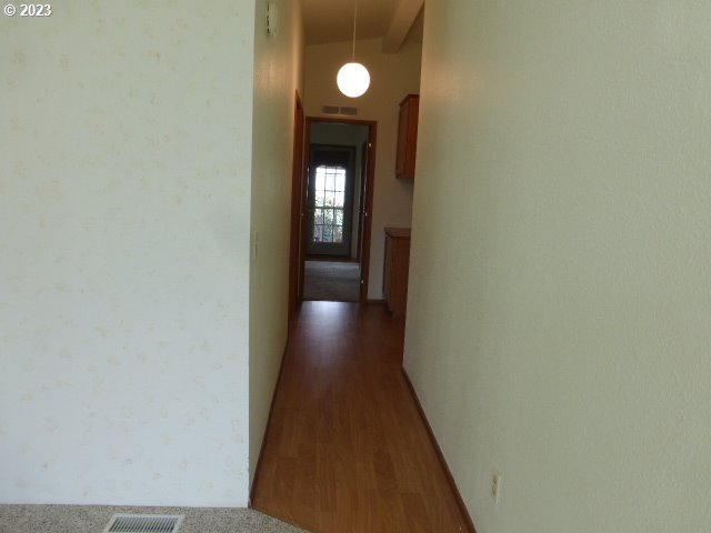 100 River Bend Road, Unit 80 Reedsport, OR 97467 - Photo 11 of 22 a view of a hallway with wooden floor and windows