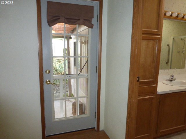 100 River Bend Road, Unit 80 Reedsport, OR 97467 - Photo 13 of 22 a bathroom with a sink a mirror and a window