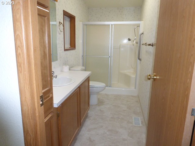 100 River Bend Road, Unit 80 Reedsport, OR 97467 - Photo 14 of 22 a bathroom with a sink a toilet and shower