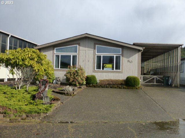 100 River Bend Road, Unit 80 Reedsport, OR 97467 - Photo 2 of 22 front view of a house with patio
