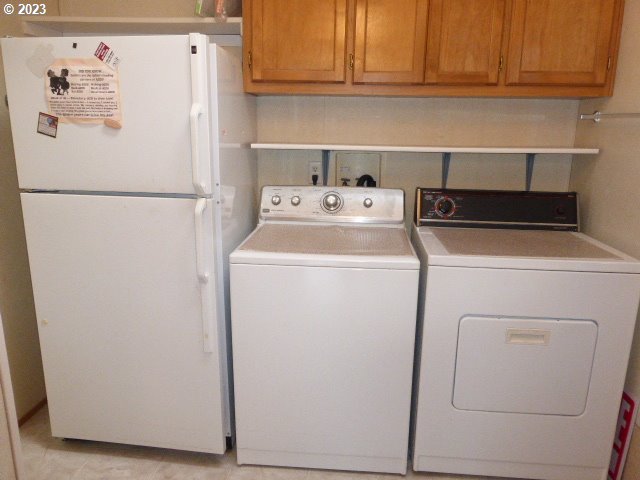 100 River Bend Road, Unit 80 Reedsport, OR 97467 - Photo 21 of 22 a white refrigerator freezer sitting in a kitchen