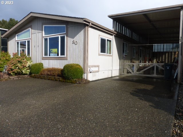 100 River Bend Road, Unit 80 Reedsport, OR 97467 - Photo 3 of 22 a front view of a house with garden