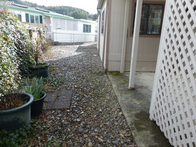 100 River Bend Road, Unit 80 Reedsport, OR 97467 - Photo 4 of 22 a view of a back yard of the house