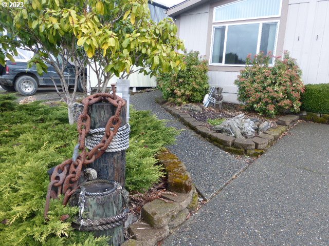 100 River Bend Road, Unit 80 Reedsport, OR 97467 - Photo 5 of 22 front view of a house with a yard