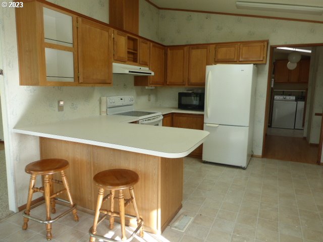 100 River Bend Road, Unit 80 Reedsport, OR 97467 - Photo 8 of 22 a kitchen with stainless steel appliances a stove a refrigerator and cabinets