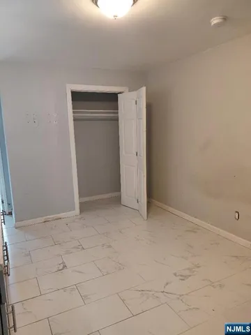 a view of an empty room and closet area