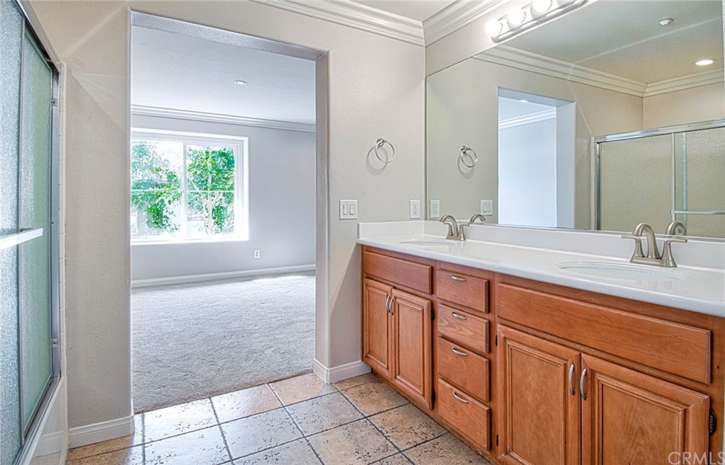 83 Sapphire, Unit 46 Irvine, CA 92602 - Photo 11 of 18 a bathroom with a sink a vanity and a mirror
